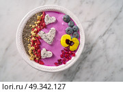 Acai bowl smoothie pitaya hearts blueberry goji chia pomegranate and seeds for Valentines day. Стоковое фото, агентство Ingram Publishing / Фотобанк Лори