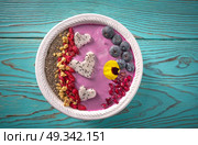 Acai bowl smoothie pitaya hearts blueberry goji chia pomegranate and seeds for Valentines day. Стоковое фото, агентство Ingram Publishing / Фотобанк Лори