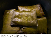 Tamale Mexican food recipe with banana leaves steamed. Стоковое фото, агентство Ingram Publishing / Фотобанк Лори