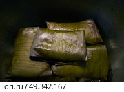 Tamale Mexican food recipe with banana leaves steamed. Стоковое фото, агентство Ingram Publishing / Фотобанк Лори