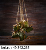 Zongzi Glutinous sticky Rice Dumplings recipe wrap with bamboo leaves asian food. Стоковое фото, агентство Ingram Publishing / Фотобанк Лори
