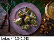Zongzi Glutinous sticky Rice Dumplings recipe wrap with bamboo leaves asian food. Стоковое фото, агентство Ingram Publishing / Фотобанк Лори