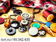 sewing tools for needlework. Buttons from clothes, sewing cloth, threads and scissors. Стоковое фото, агентство Ingram Publishing / Фотобанк Лори