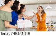 Three women have arrived for birthday celebration and presenting gift to birthday woman. Стоковое фото, фотограф Яков Филимонов / Фотобанк Лори