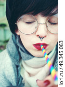 Young pretty woman with a rainbow straw. Стоковое фото, агентство Ingram Publishing / Фотобанк Лори