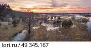 Spring melting river flood panorama. Sunset over thaw meadows. Streaming water at early springtime. Drone view. Стоковое фото, агентство Ingram Publishing / Фотобанк Лори