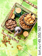 Roasted coffee beans. Coffee beans, cardamom, spices sugary in a stylish basket. Стоковое фото, агентство Ingram Publishing / Фотобанк Лори