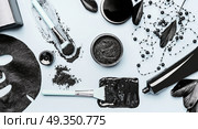 Activated Charcoal facial cosmetic setting with  powder, Black head Mask, sheet mask and beauty tools accessories , top view, flat lay. Modern beauty and skin care concept. Стоковое фото, агентство Ingram Publishing / Фотобанк Лори