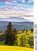 Inspiring evening light in spring. Sunset in Tatra Mountains, Poland. Mountain ridge over cloudy sky. Evening light in spring. Sunset in Tatra Mountains, Poland. Стоковое фото, агентство Ingram Publishing / Фотобанк Лори