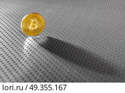 Bitcoin BTC coin shadow on the silver soil. Bitcoin BTC coin shadow on the soil silver background. Стоковое фото, агентство Ingram Publishing / Фотобанк Лори