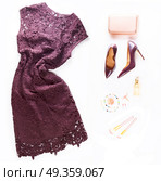 Fashion Christmas flat lay scene. Fashion flat lay scene. Hight heel shoes, dress, bag, dressing up for party fashion accessoires. Стоковое фото, агентство Ingram Publishing / Фотобанк Лори