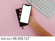 One hand holding New Iphone X mobile phone with cup of colorful apps icons. Modern phone mock up. Modern phone mock up. Стоковое фото, агентство Ingram Publishing / Фотобанк Лори