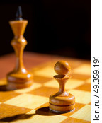 Chessboard with figures on dark background. Стоковое фото, агентство Ingram Publishing / Фотобанк Лори