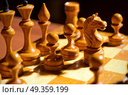 Chessboard with figures on dark background. Стоковое фото, агентство Ingram Publishing / Фотобанк Лори