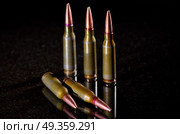 Ammunition cartridges on black background. Ammunition cartridges. Стоковое фото, агентство Ingram Publishing / Фотобанк Лори