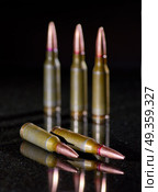 Ammunition cartridges on black background. Ammunition cartridges. Стоковое фото, агентство Ingram Publishing / Фотобанк Лори