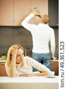 The drinking husband and the upset wife on kitchen. Addiction. Стоковое фото, агентство Ingram Publishing / Фотобанк Лори