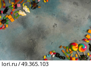 Colorful halloween candies on stone. Trick and treat - colorful halloween candies frame on stone background with copy space. Стоковое фото, агентство Ingram Publishing / Фотобанк Лори