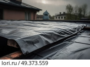 A tarp is covering a roof, with a house visible in the background. Стоковое AI-изображение, AI-художник Данила Большаков / Фотобанк Лори