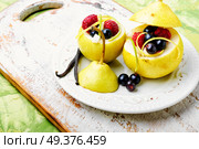Autumn pear with currant and raspberry filling. Pear with berry stuffing. Стоковое фото, агентство Ingram Publishing / Фотобанк Лори