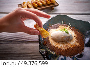 hand holding pastry on Ice cream dessert with milk and coffee. Стоковое фото, агентство Ingram Publishing / Фотобанк Лори