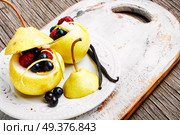 Autumn pear with currant and raspberry filling. Pear with berry stuffing. Стоковое фото, агентство Ingram Publishing / Фотобанк Лори