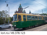 on the streets of Helsinki there is a tram in the background  Uspenski Cathedral. . Стоковое фото, агентство Ingram Publishing / Фотобанк Лори