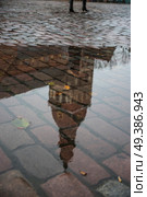 Riga Church of St. Peter . in the autumn after a rain in puddles the buildings are reflected. Стоковое фото, агентство Ingram Publishing / Фотобанк Лори