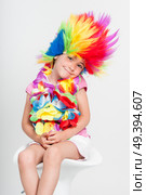 Funny beautiful party little girl in disguise with wig in many colors. Стоковое фото, агентство Ingram Publishing / Фотобанк Лори
