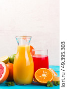 Citrus juices - red and yellow one with oranges and grapefruits. Citrus juices. Стоковое фото, агентство Ingram Publishing / Фотобанк Лори