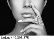 Beauty Fashion woman lips with natural Makeup and white Nail polish. Gloss Blue Lipstick. Beauty girl face close up. Sexy Lips, Manicure, Make up. Ring with Precious Stones, Jewelry. Стоковое фото, агентство Ingram Publishing / Фотобанк Лори