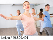 Smiling young adult couples dancing together in pairs and practicing movements in modern choreography class. Стоковое фото, фотограф Яков Филимонов / Фотобанк Лори