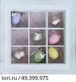 Easter tic tac toe game with eggs and rabbits in box clos eup - pastel colors and rustic style. Easter eggs in box. Стоковое фото, агентство Ingram Publishing / Фотобанк Лори