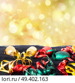 Carnaval festive decorations isolated borer over white background with copy space. Carnaval decorations on dark wooden background. Стоковое фото, агентство Ingram Publishing / Фотобанк Лори
