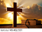 Christian wood cross on sunset sky wooden made with Bible and rosary beads. Стоковое фото, агентство Ingram Publishing / Фотобанк Лори
