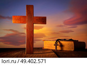 Christian wood cross on sunset sky wooden made with Bible and rosary beads. Стоковое фото, агентство Ingram Publishing / Фотобанк Лори
