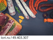 spanish tapas with salami, chorizo, lomo, jamon with red hot salsa sause and olives, picnic table, top view with copy space, retro toned. Picnic table with spanish sausage tapas. Стоковое фото, агентство Ingram Publishing / Фотобанк Лори