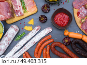spanish tapas with salami, chorizo, lomo, jamon with red hol salsa sause and olives, picnic table, top view. Picnic table with spanish sausage tapas. Стоковое фото, агентство Ingram Publishing / Фотобанк Лори