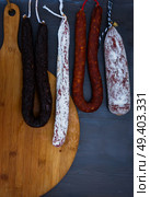 Cured meat and sausages hanging a rack at market.. Cured meat and sausages. Стоковое фото, агентство Ingram Publishing / Фотобанк Лори