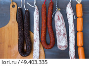 Cured meat and sausages hanging at market. Cured meat and sausages. Стоковое фото, агентство Ingram Publishing / Фотобанк Лори