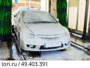 Washing one gray car with soap on station. Washing gray car. Стоковое фото, агентство Ingram Publishing / Фотобанк Лори