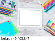 back to school hero header with school supplies on wooden table, copy space on blank screen of tablet. back to school frame. Стоковое фото, агентство Ingram Publishing / Фотобанк Лори