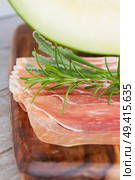 platter of spanish cured pork ham jamon close up with melon. Стоковое фото, агентство Ingram Publishing / Фотобанк Лори