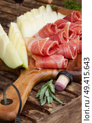 spanish tapas  - slices of cured pork ham jamon with melon . spanish tapas. Стоковое фото, агентство Ingram Publishing / Фотобанк Лори