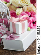 gift boxes for valentines day with pink ribbon bow and bunch of fresh roses and eustoma flowers  . pink and white flowers. Стоковое фото, агентство Ingram Publishing / Фотобанк Лори
