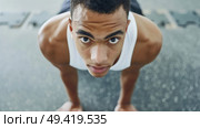 A man is performing push ups while balancing on a skateboard. He shows strength and balance in this athletic feat. Стоковое AI-изображение, AI-художник Данила Большаков / Фотобанк Лори