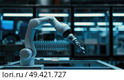 A robotic arm with a screwdriver attached precisely tightens a screw in a manufacturing facility. Automated technology streamlines production processes efficiently. Стоковое AI-изображение, AI-художник Данила Большаков / Фотобанк Лори