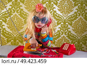 Sad housewife kid girl iron chores talking at red retro phone vintage humor. Стоковое фото, агентство Ingram Publishing / Фотобанк Лори