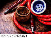 Oriental exotic hookah .Smoking turkish shisha.Tobacco in a snuffbox and hookah. Smoking hookah with tobacco. Стоковое фото, агентство Ingram Publishing / Фотобанк Лори