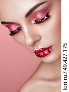 Face of Beautiful Woman with Holiday Makeup Heart. Valentine’s Day Make-up. Lips in Pink Lipstick. Makeup detail. Face of Girl on a Pink Background. Lashes Which are Glued with Hearts. Стоковое фото, агентство Ingram Publishing / Фотобанк Лори